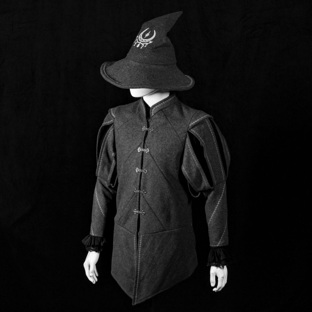 Mannequin wearing a grey wool doublet with a matching embroidered witch hat