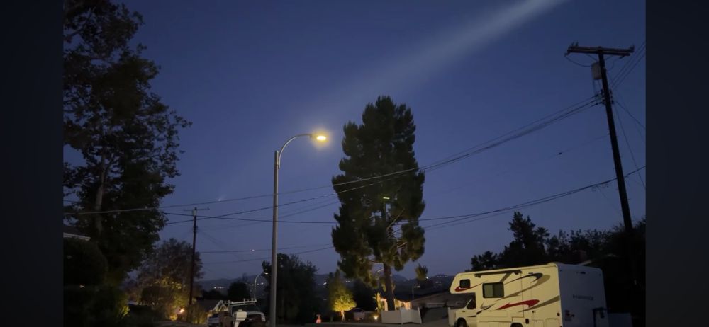 SpaceX launch tonight out of Vandenberg as seen from LA. Left side high, between trees & street light, second stage just before SECO. Just to the left of the street light pole, lower down, the bright dot is the reentry burn of the first stage!