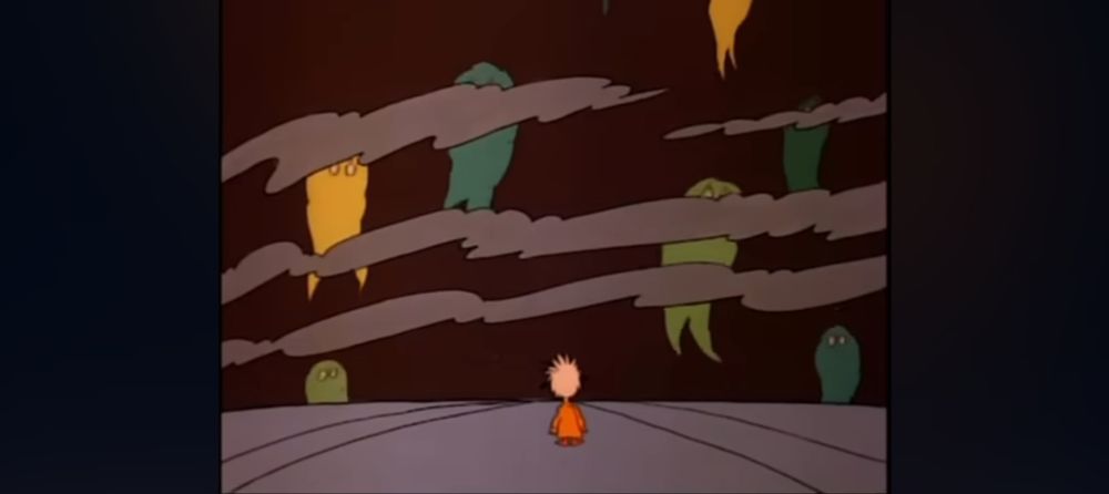 The Who child looking at different-coloured ghostly shapes flying up from the horizon, behind dark clouds.