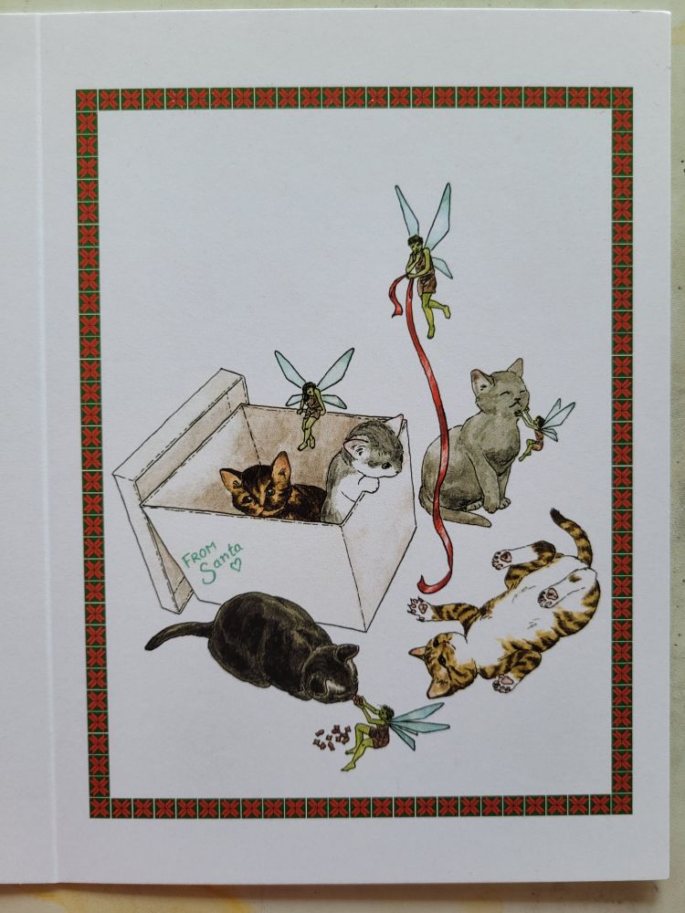 Print of an ink and watercolor illustration of five kittens who have escaped a box labeled "From Santa." Four green faeries, who have probably helped in this escape, fly around the brood. They pet, feed and play with the newly freed kittens.