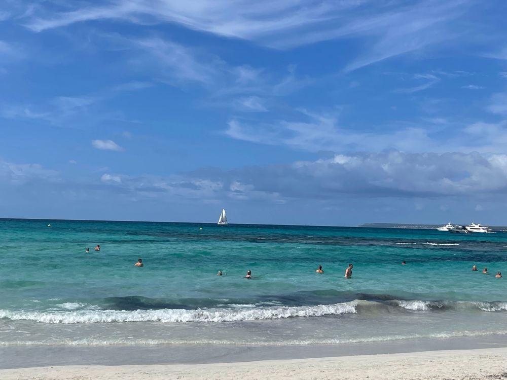 Beach with blue ocean waters amd clouds 
