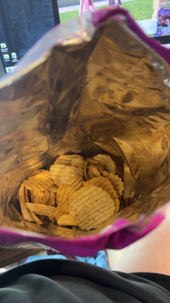 Open large bag of chips with 3/4 of the bag being empty