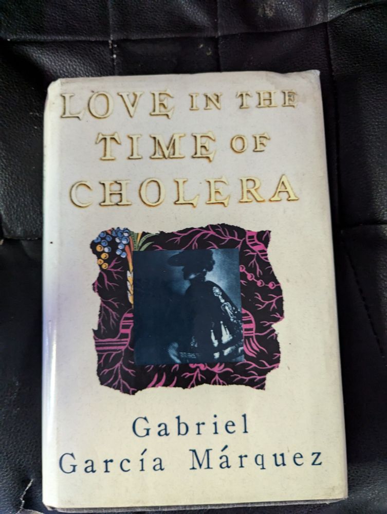 The cover of Gabriel Garcia Marquez 's "Love in the Time of Cholera" against a cream background. 
