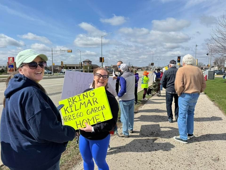 Crowd of people holding signs