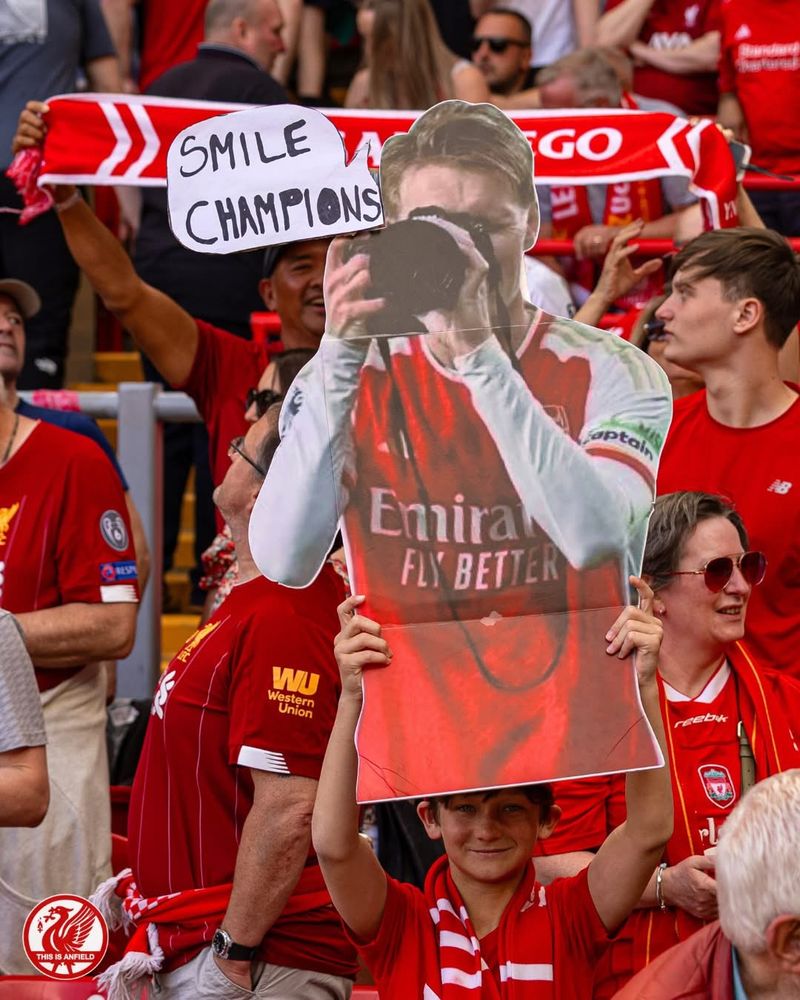 Kid holding picture of man taking photo