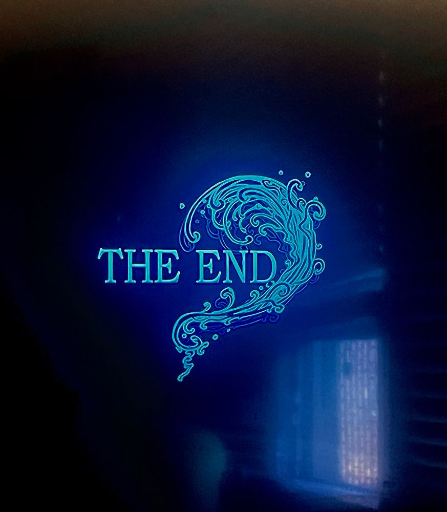 The words “THE END” with sort of a watery wave going up and around the right side appear on a television screen.