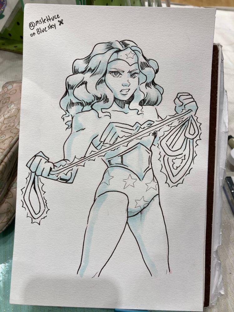 A sketch of Wonder Woman with a fierce expression, holding her lasso