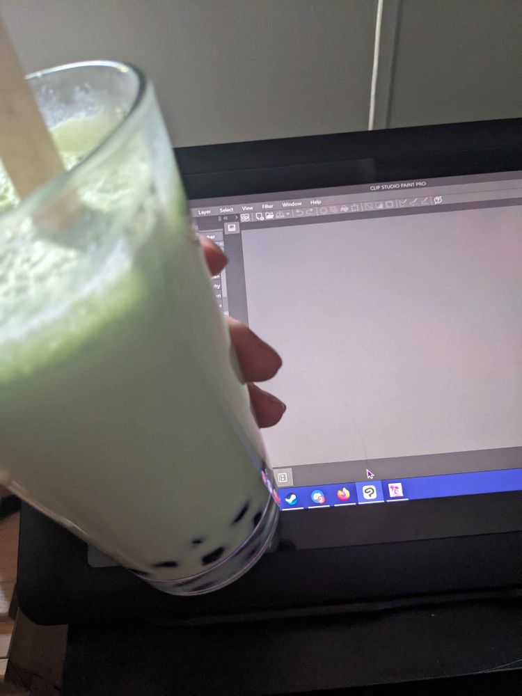 Holding homemade boba with my art tablet in the background