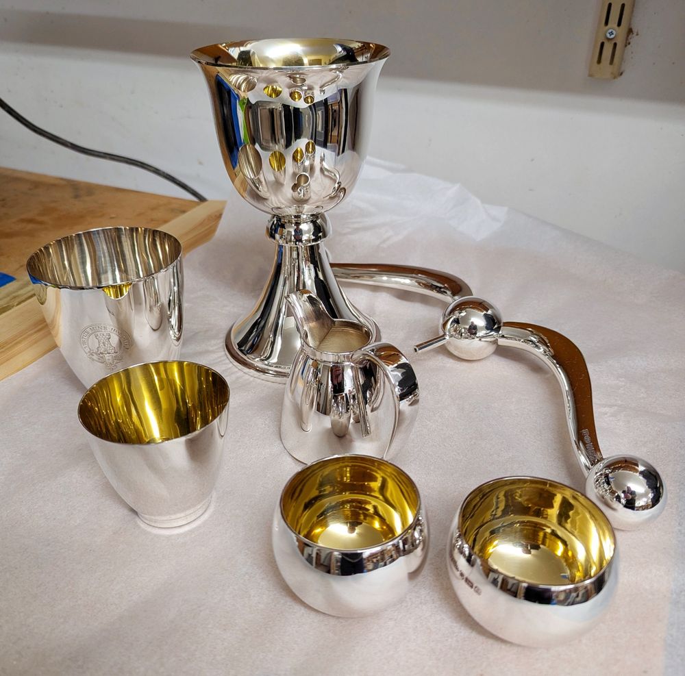 Sterling silver tableware for drinking water and whisky (seperately), serving cream and lighting the table.