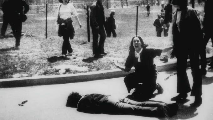 Student Mary Ann Vecchio gestures and screams as she kneels by the body of a student lying face down on the campus of Kent State University on May 4, 1970. John Filo/AP