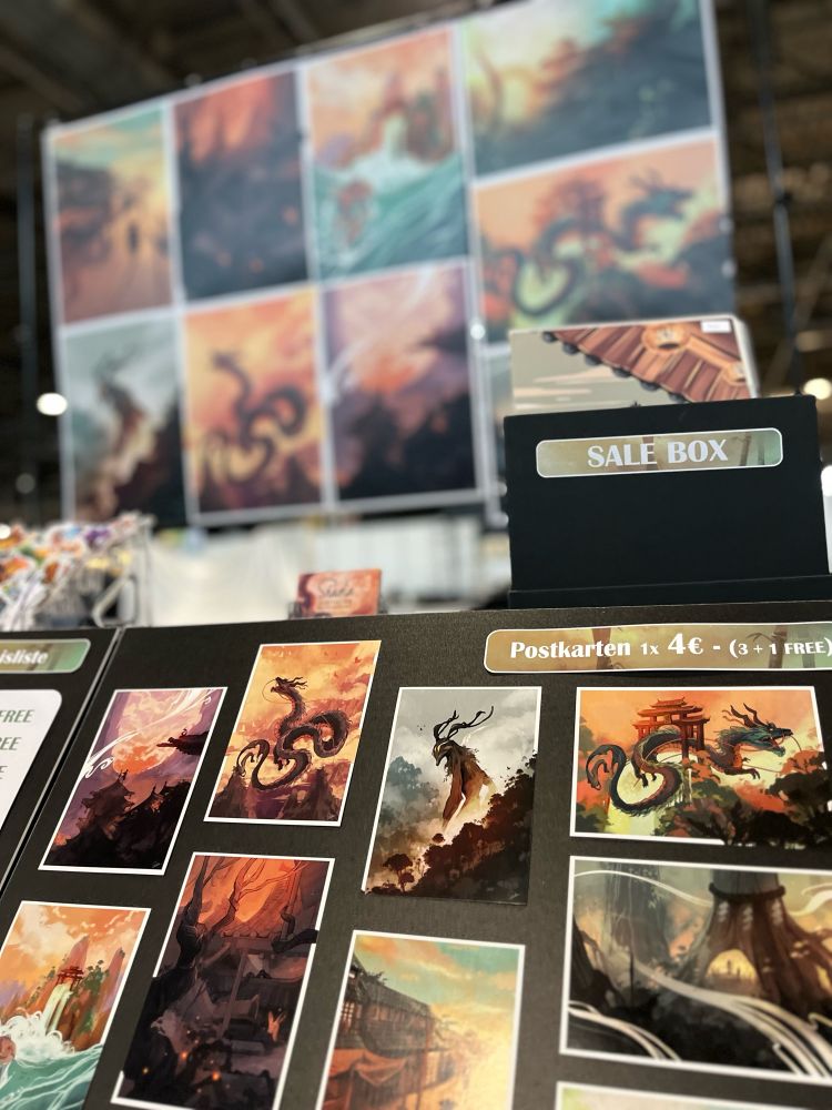 Artist Alley booth with prints and postcards 