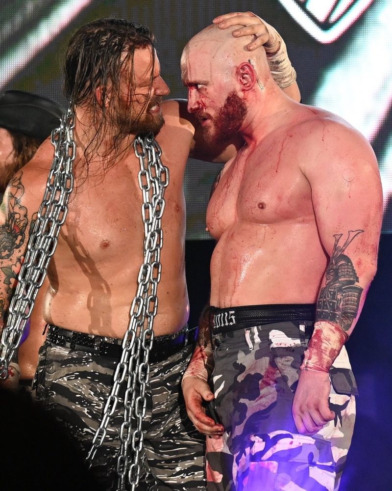David Finlay and Gabe Kidd post-Dontaku dog pound match. Finlay is wearing a chain and has his hand on Gabe's head, while Gabe is staring into his soul