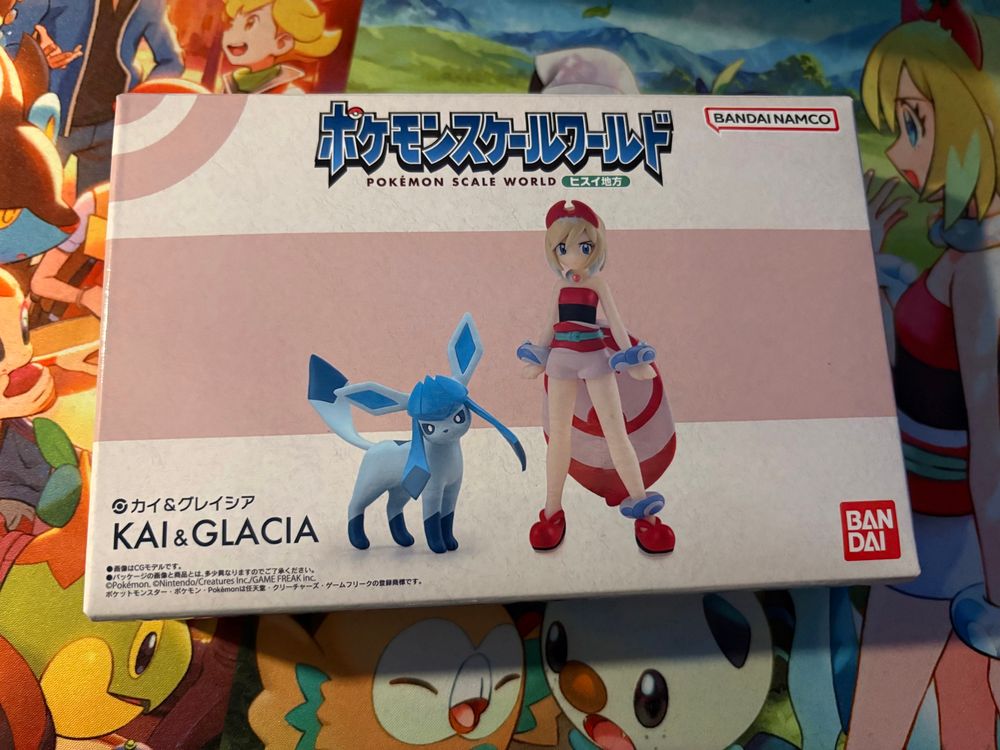 Pokemon Scale World Irida and Glaceon figure, in box. It is resting on a pokemon themed tcg play mat