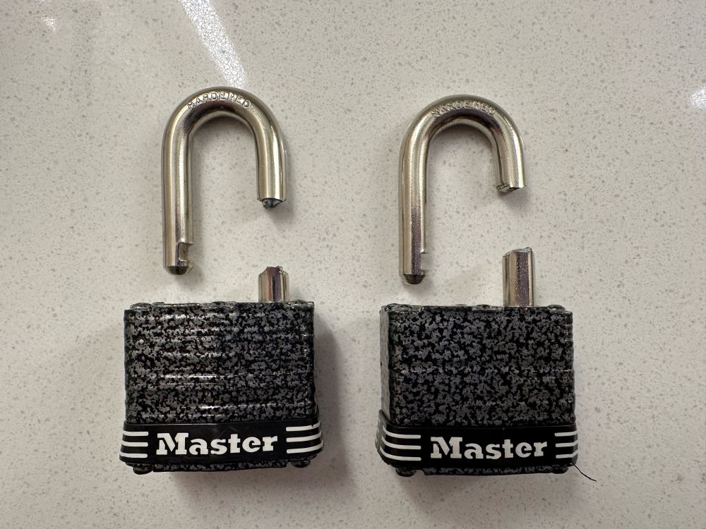 Two Master (and I use this term loosely) "locks", cleanly sliced through the shackle.