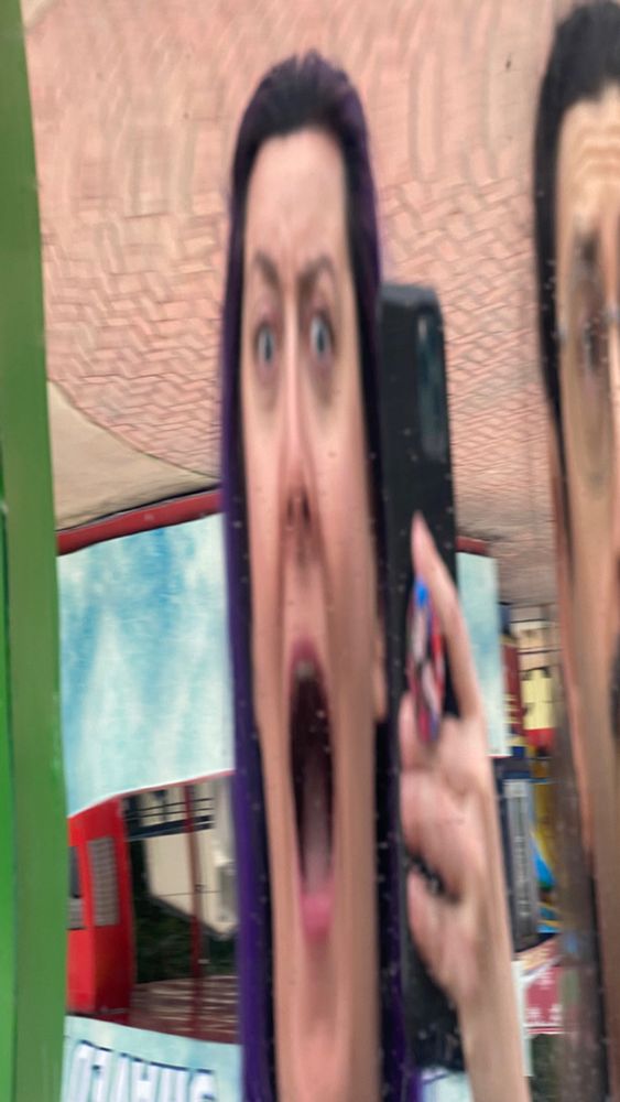 Funhouse mirror stretching my face to be impossibly tall.