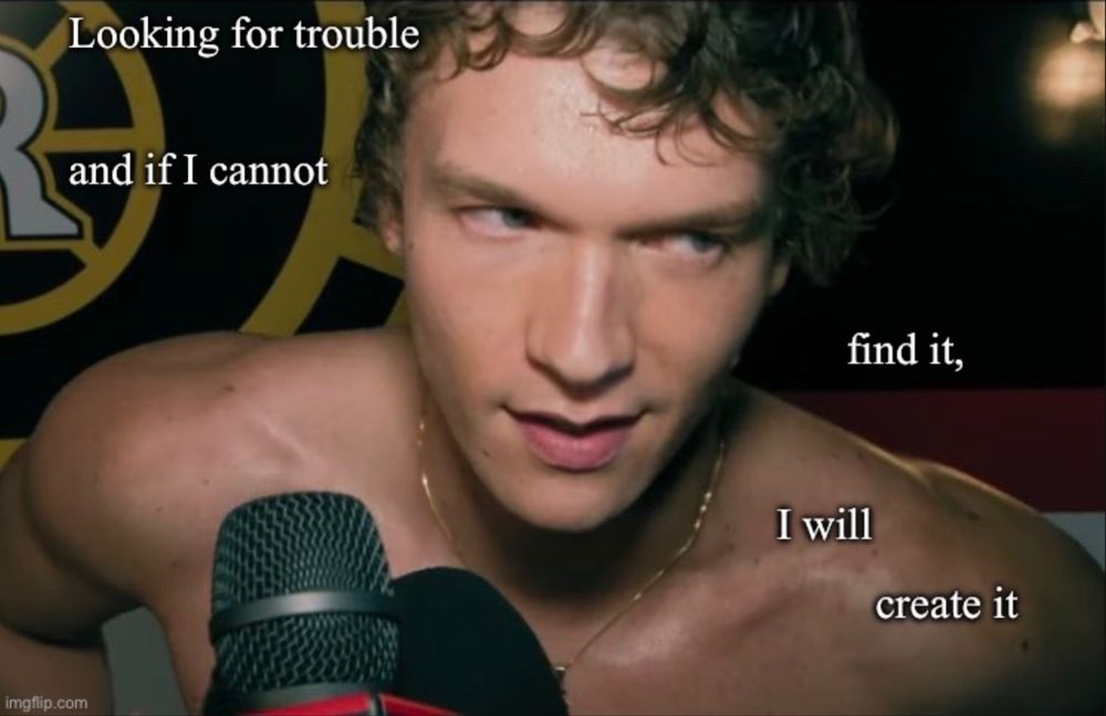 Screenshot of the heated rivalry tv show trailer showing Ilya Rozanov about to wink at the camera, naked from the waist up. There is a "The Mincing Mockingbird Guide To Troubled Birds" quote typed on it saying: "Looking for trouble and if I cannot find it, I will create it."
