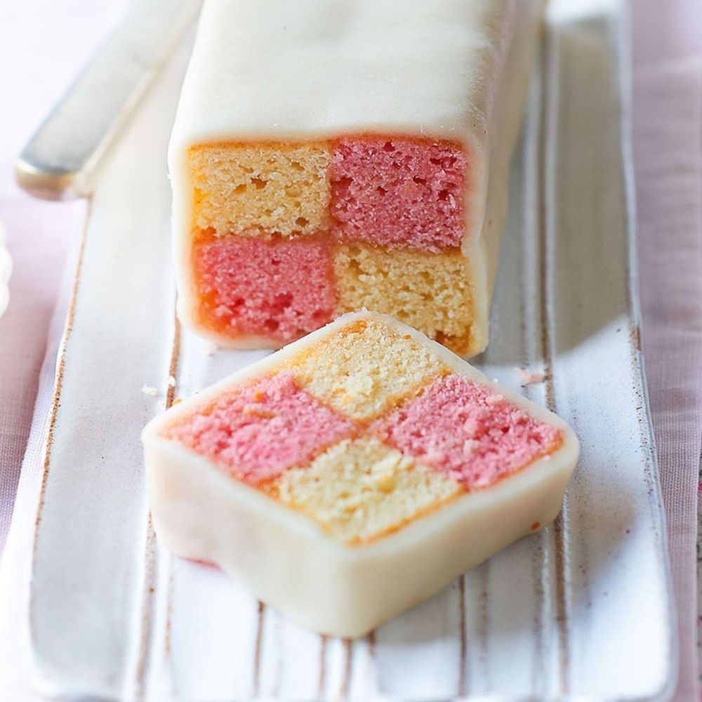 Battenberg cake. Pink and yellow squares with a red jam cross. 