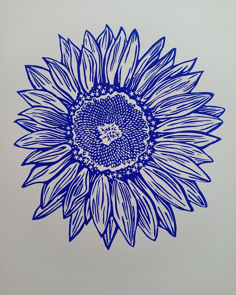 Linoprint of a sunflower, printed in blue ink