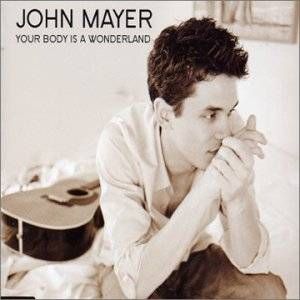 The cover, a tightly framed photo of Hohn Mayer sitting at the edge of his bed, clasping his hands to his head and looking pensive, while his guitar lies on the bed behind him.