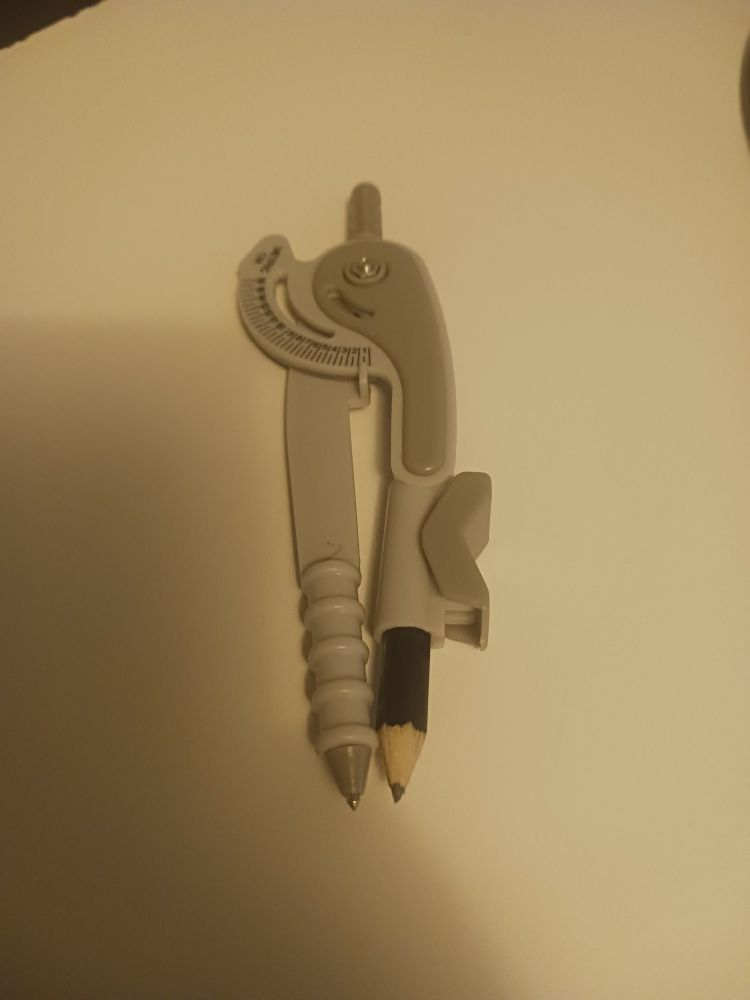 Photo of a drawing compass. There's a curved ruler at the top of it to measure the radius of the drawn circle. 