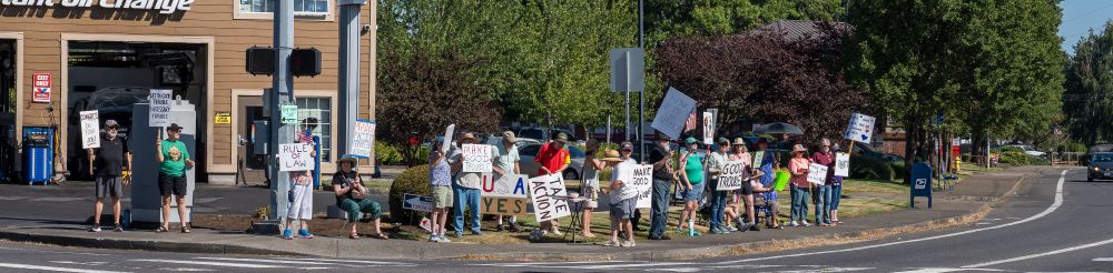 People are protesting at the corner of SE Webster and SE Thiessen. 