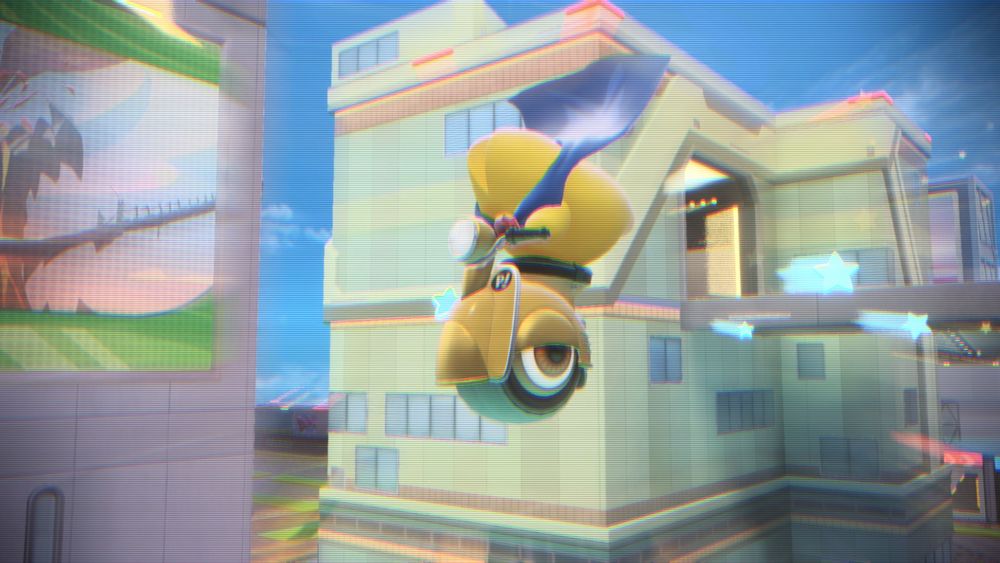 A second screenshot, this time showing Starman riding the yellow Wheelie Scooter and jumping high into the air. They appear to be flying through the sky, blue stars fluttering behind them.