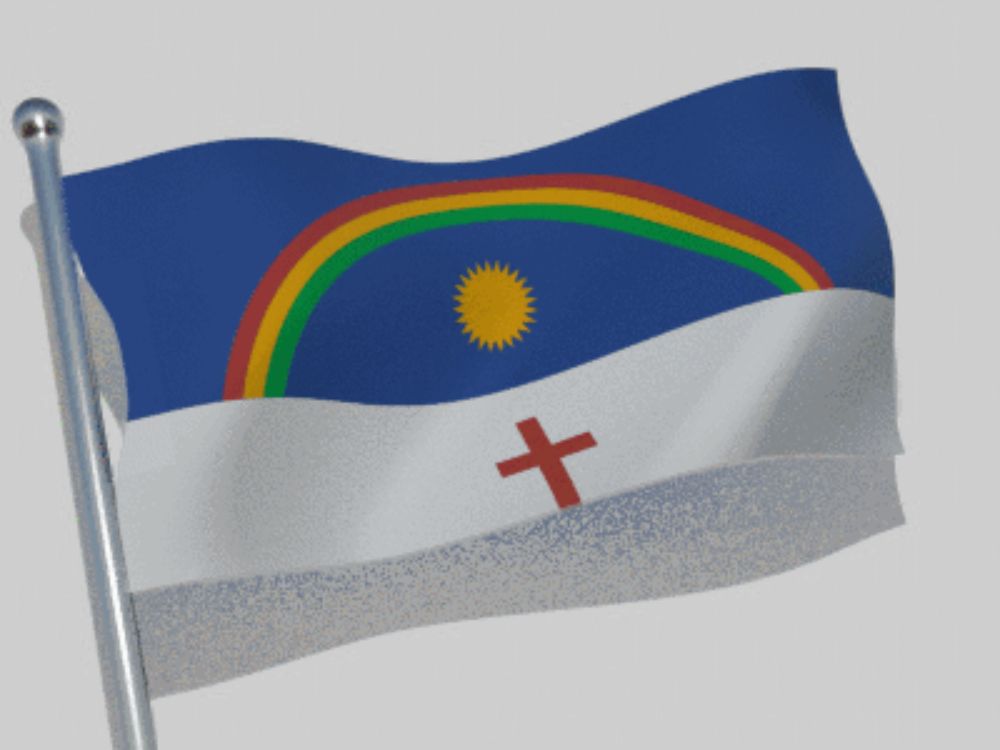 a flag with a rainbow and a cross on it is waving in the wind