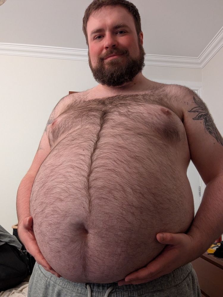 Big fat hairy man holding his gut