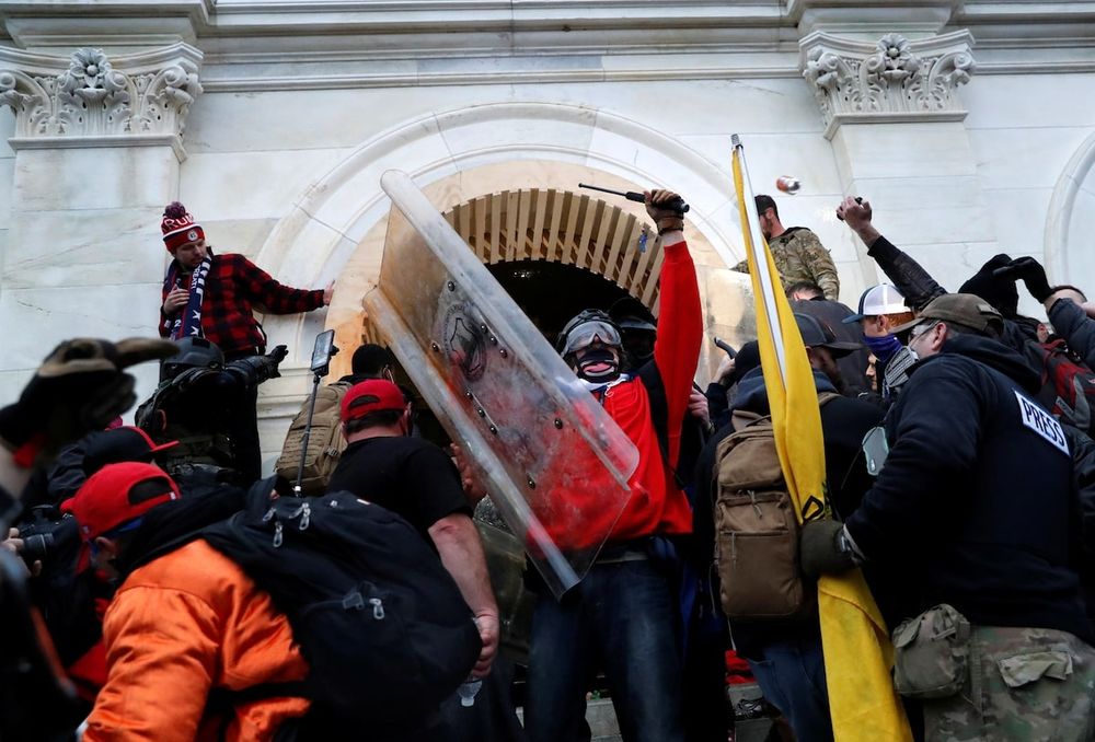 A photograph of rioters at the January 6 insurrection at Capitol Hill. Protesters swarm and occupy the front entrancr.