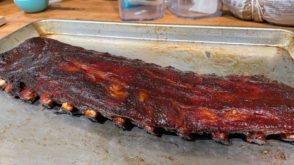A full rack of ribs, rubbed with spices, smoked for 3 hours, and eventually topped with barbecue sauce.