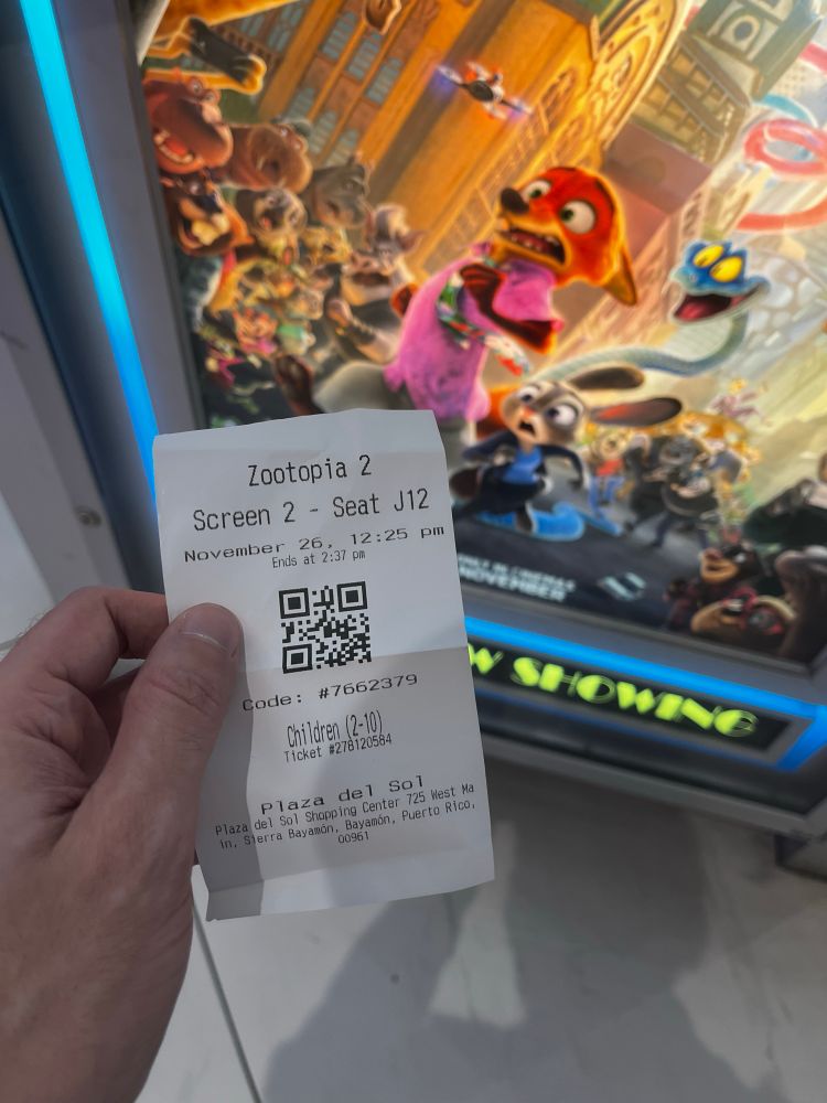 Zootopia 2 movie ticket in front of Coming Soon poster