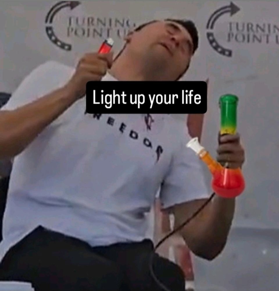 Man with a bong and a lighter  in a g white shirt 