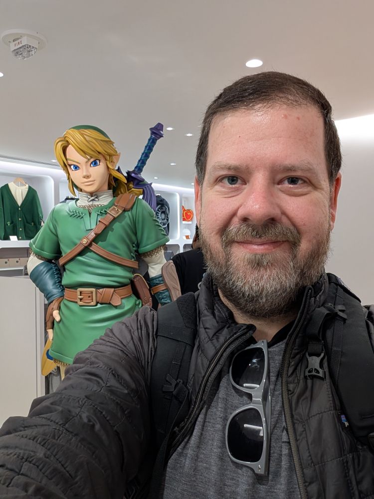 A selfie of me in front of a Link statue at the Nintendo Store in San Francisco.