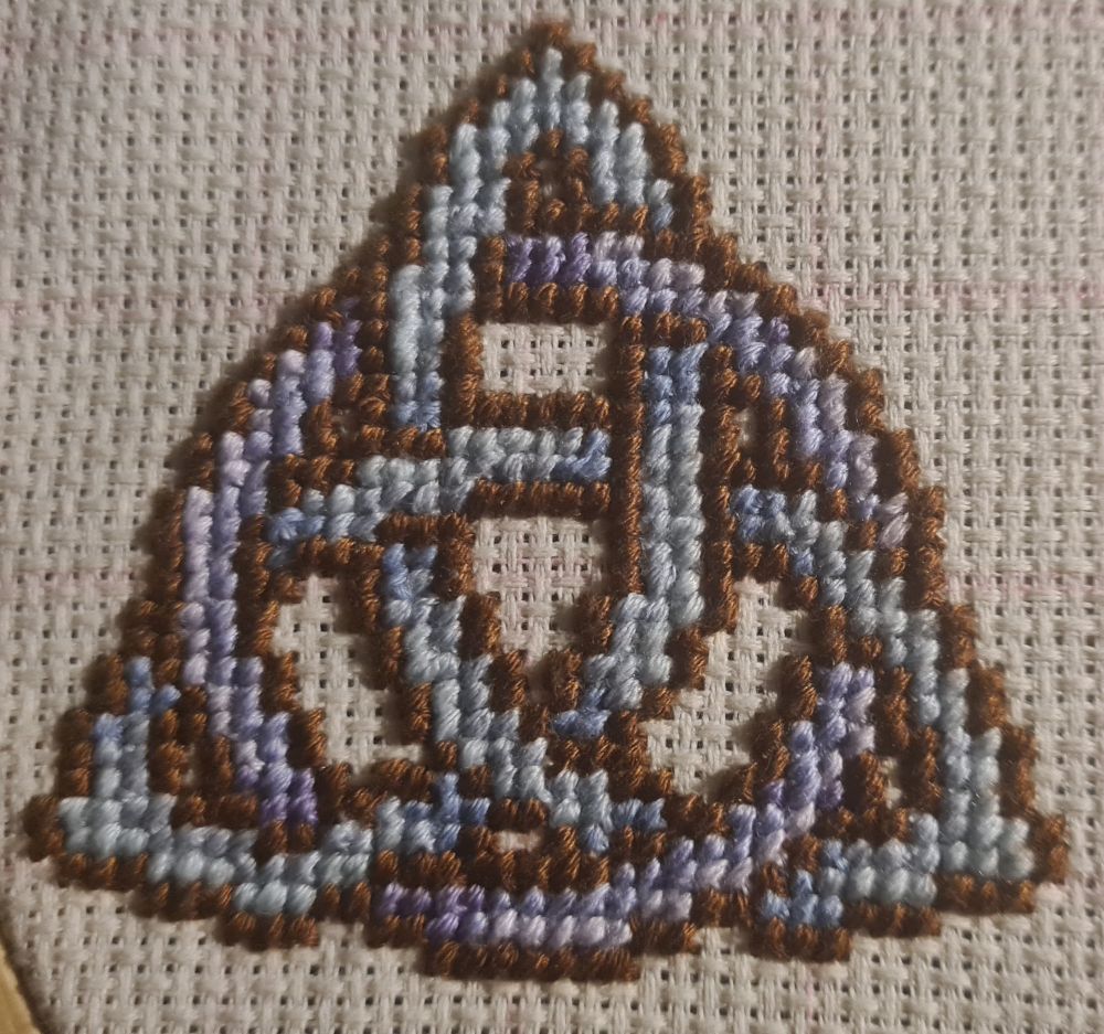 Celtic Knot Cross stitch in light blue and purple lined in chocolate brown