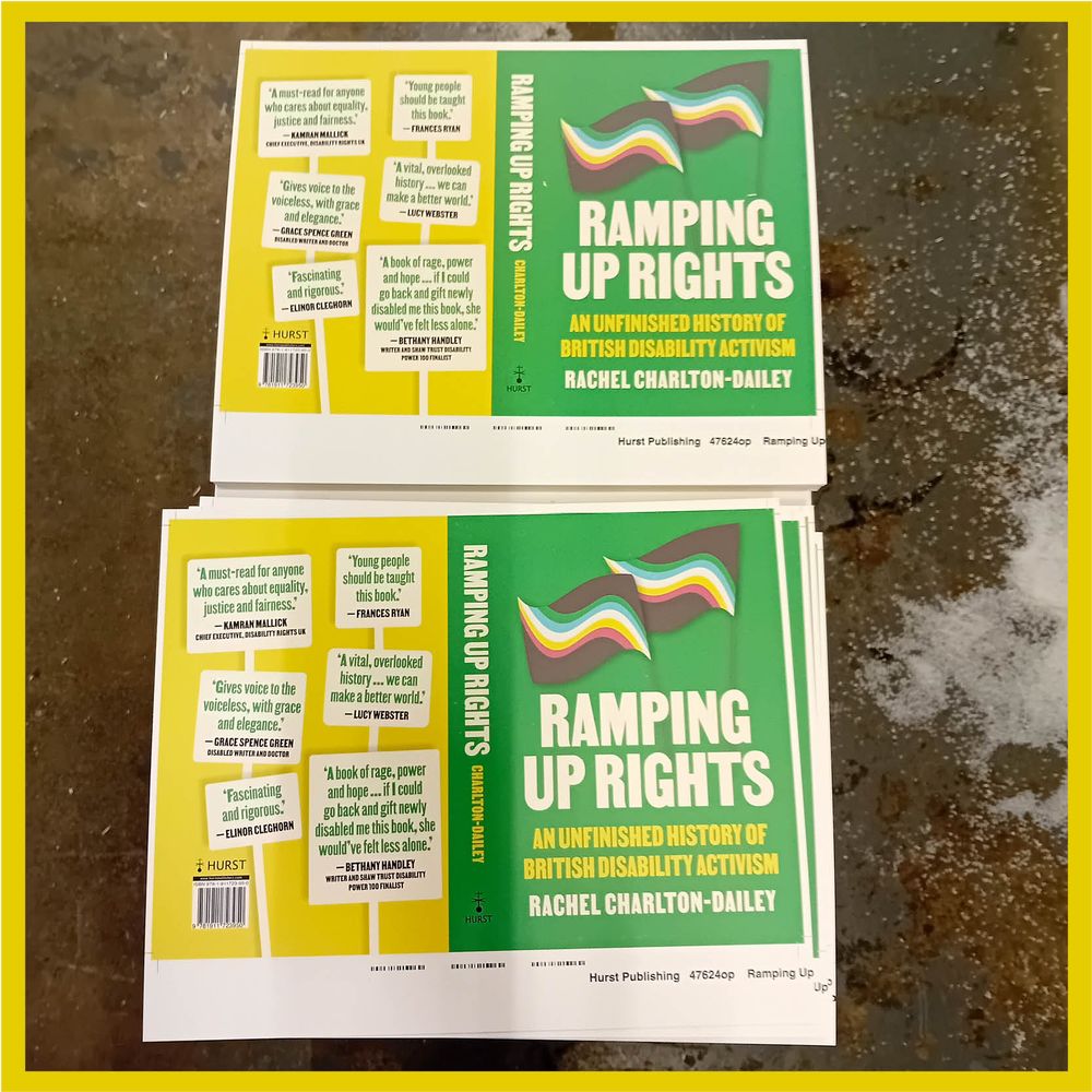 Two printed book jackets for Ramping Up Rights by Rachel Charlton-Dailey, laid flat at a printer’s, showing the bright green cover with disability pride flags and endorsements on the back.