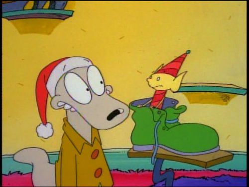 Rocko wearing a Santa hat, and a yellow Elf in a shoe.