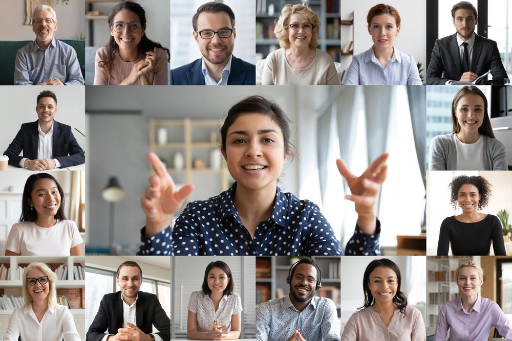 Group of people in boxes talking and smiling during a virtual session