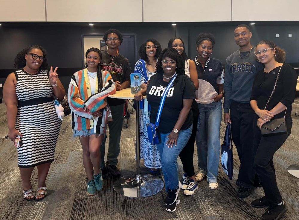 A group of alumni proudly pose together after attending the African American Community-Wide celebration, where they offered advice and insight from alumni to students, parents, and families.
