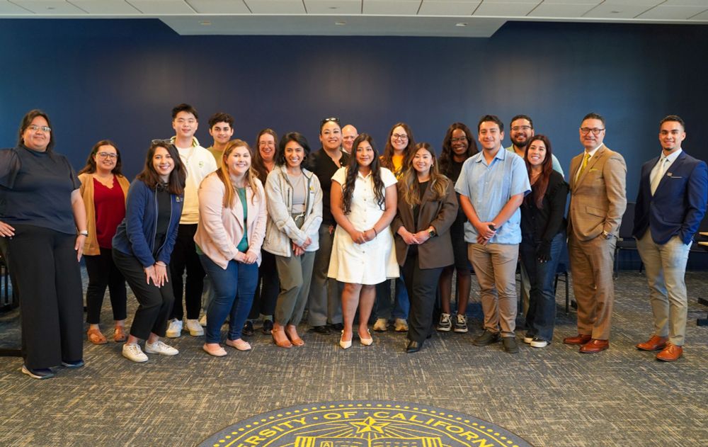 Alumni now working as staff and faculty take a group photo with Chancellor Muñoz.