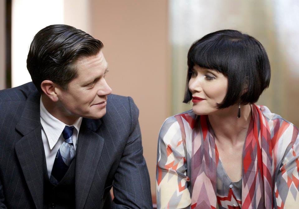 Inspector Jack Robinson gazing at Miss Phryne Fisher with charm and adoration