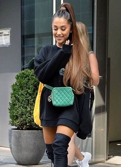 Ariana grande with long pony in a big sweater and thigh highs