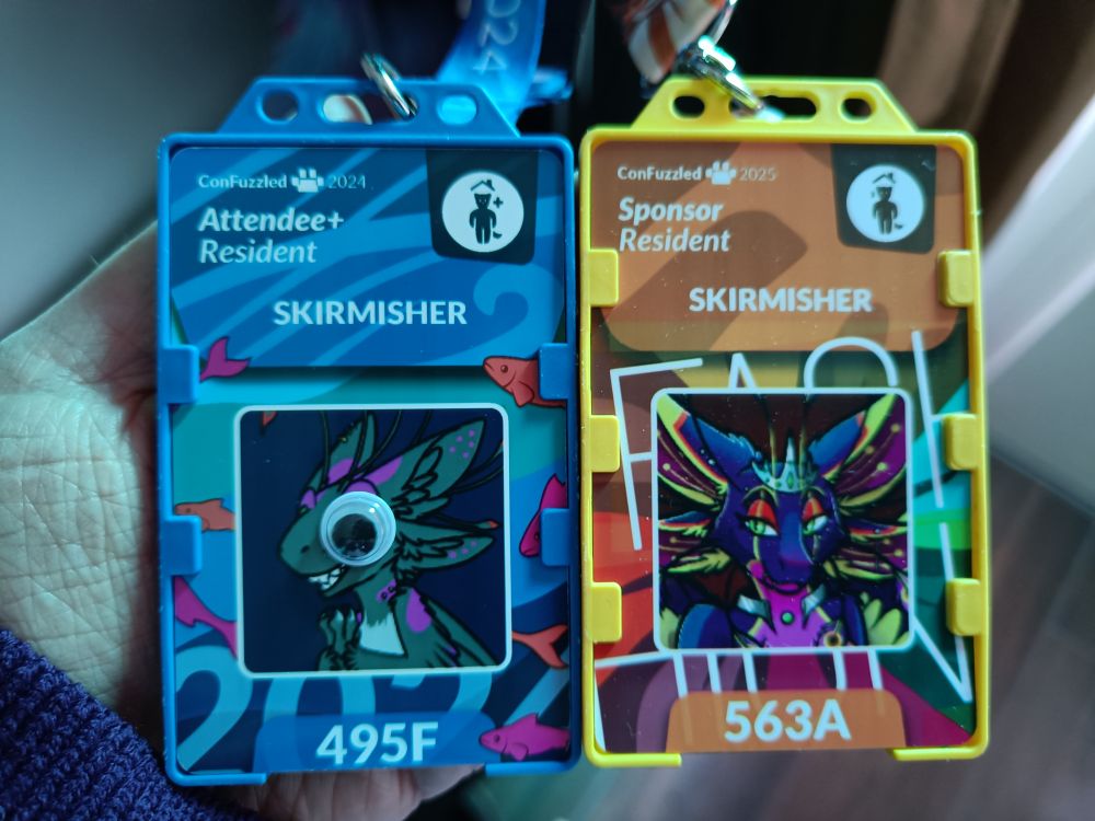 Two con badges, one from confuzzled 2024, one from 2025. the 2024 is attendee, the 2025 is sponsor. 