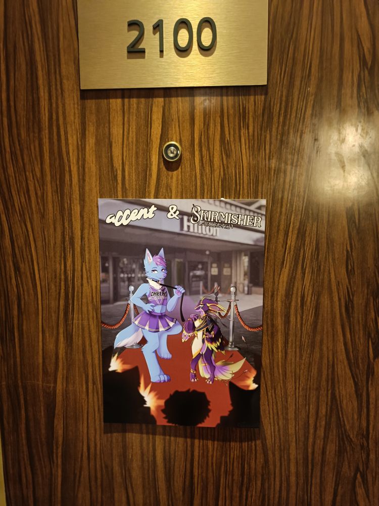 A picture of a hotel room door with furry room art of Accent and Skirmisher on it