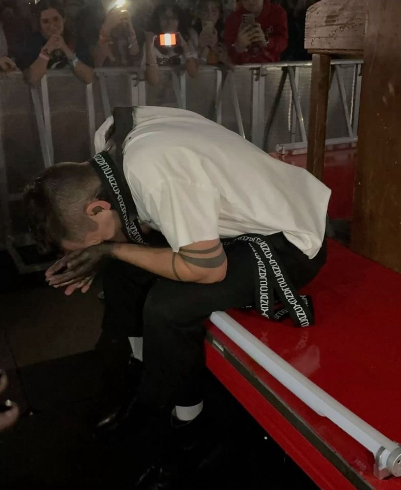 tyler joseph despairing with his head in his hands while sitting on his clancy tour B stage riser