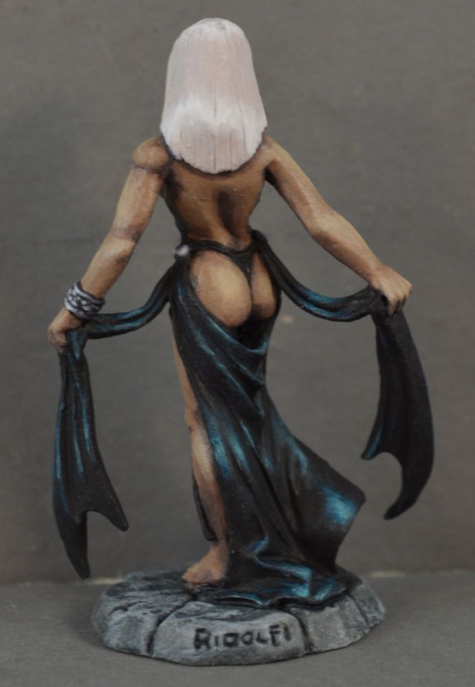 Painted figure of a medium-dark skinned female with white hair wearing a skimpy black dress that shows a lot of her butt. Back view. 