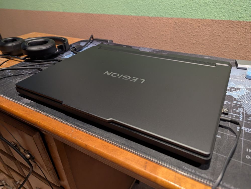 My laptop, a Lenovo Legion Pro 7i Gen 10, who I named Determination, silently sitting on a desk with his lid closed.