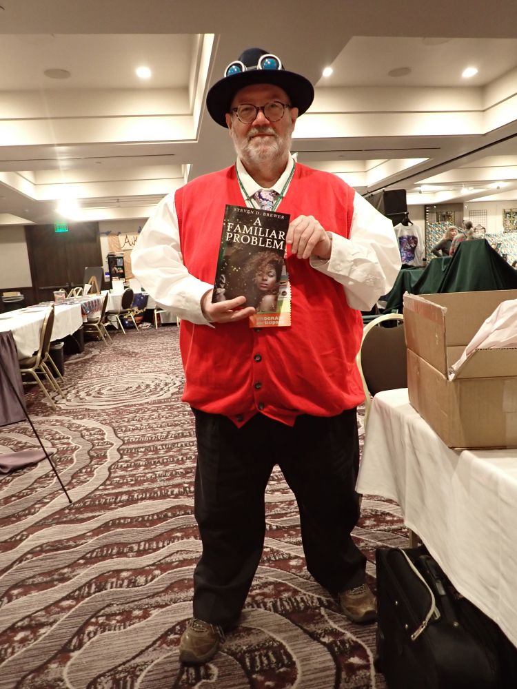 a man holding a copy of A Familiar Problem