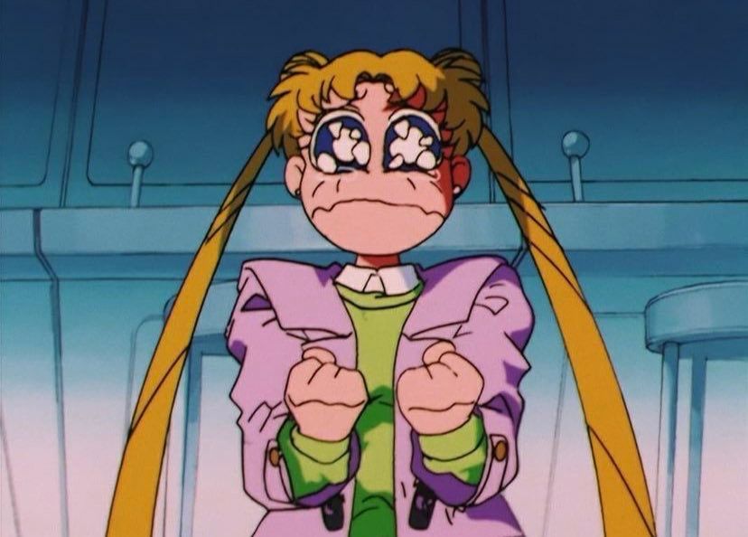 Usagi holds her fists in close to her chest and cries dramatically 