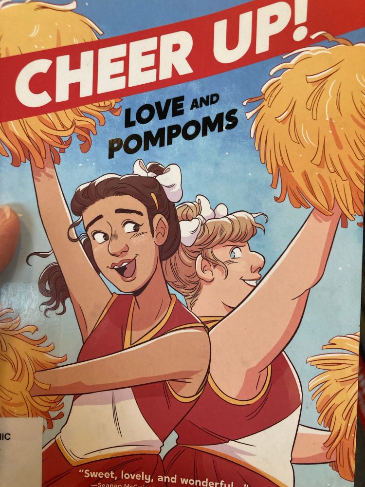 Two cheerleaders back-to-back in blue and white uniforms, holding yellow Pom poms with the title across the top: “Cheer Up! Love and Pompoms”