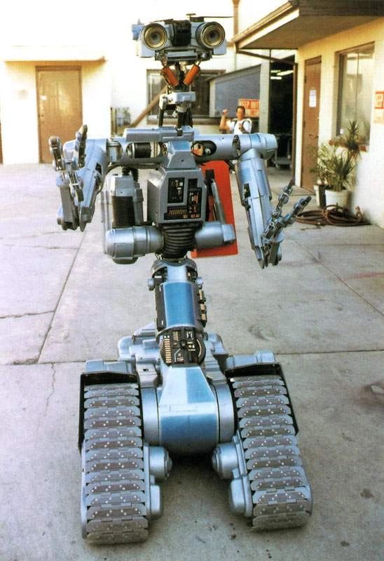 Johnny 5, an upright robot on tank strips with big eyes from the movie Short Circuit